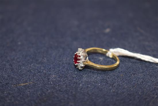 A modern 18ct gold, ruby and diamond cluster ring, size L.